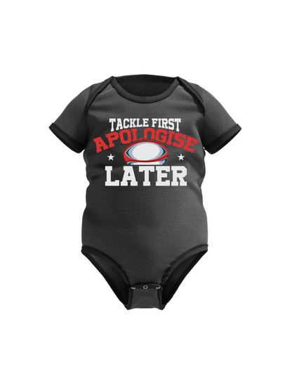 Black baby onesie with humorous text design on a white background with a Cows Corner tackle first apologise later