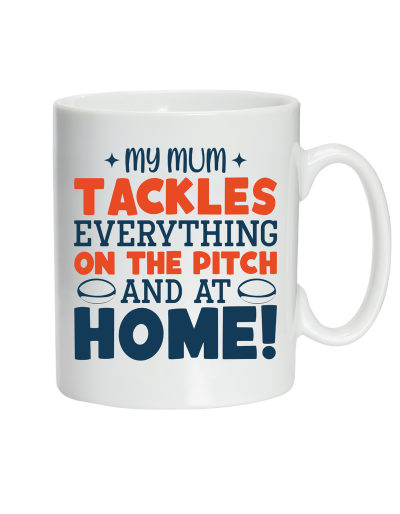 White mug with colorful text on a white background., with a slogan on the front saying 'My Mum Tackles Everything on the Pitch and at Home!'