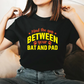 A lady wearing a black t-shirt with Mind The Gap Between Your Bat And Pads on the front. A Funny Cricket T-Shirt, Premium Fabric, Multiple Adult Sizes