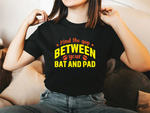 A lady wearing a black t-shirt with Mind The Gap Between Your Bat And Pads on the front. A Funny Cricket T-Shirt, Premium Fabric, Multiple Adult Sizes