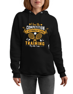 A lady wearing a black hoodie with a funny tennis slogan on the front saying 'I Love the Competition, I Actually Love Training, It’s Who I Am – Serena Williams!'