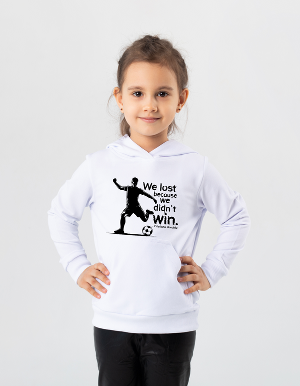 Child wearing a white hoodie with a soccer-themed design on a light gray background with the Cows Corner slogan, We lost because we didn't win - Cristiano Ronaldo