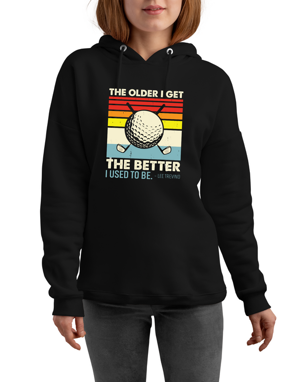 Person wearing a black hoodie with a colourful graphic and text on a white background with a Cows Corner slogan saying The older I get, the better I used to be - Lee Trevino 