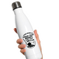 White water bottle with black text and graphic held by a hand on a white background