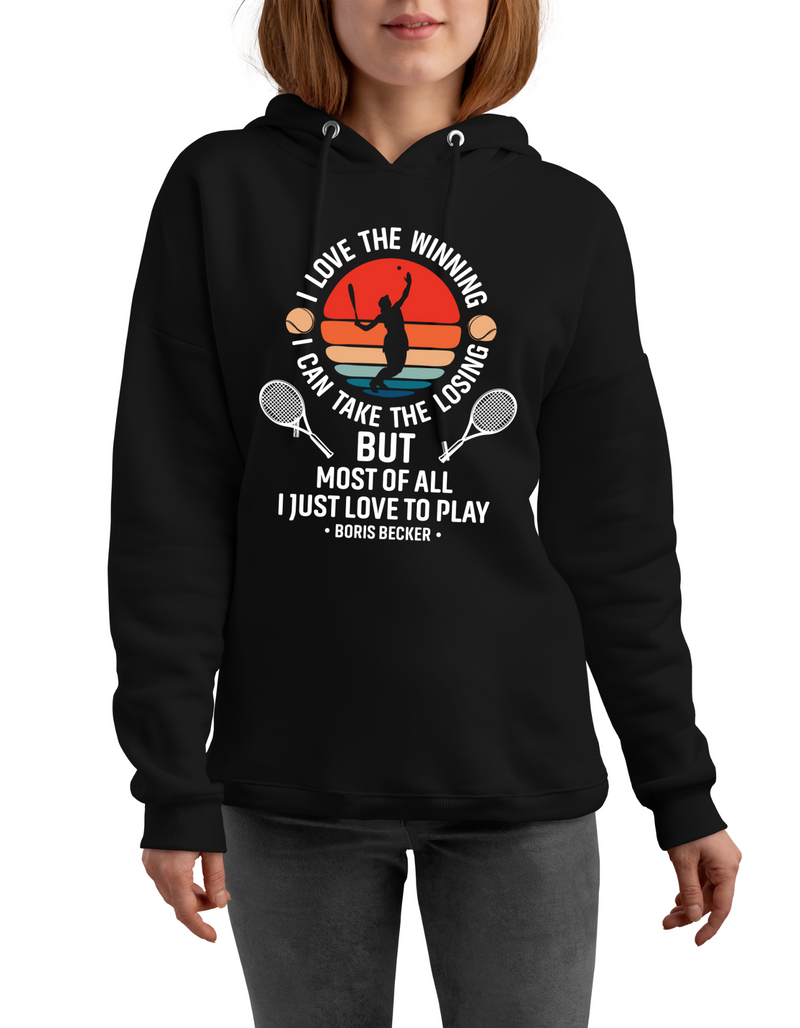 A lady wearing a black hoodie with the funny tennis slogan on the front reading 'I Love the Winning, I Can’t Take the Losing, but Most of All I Just Love To Play'