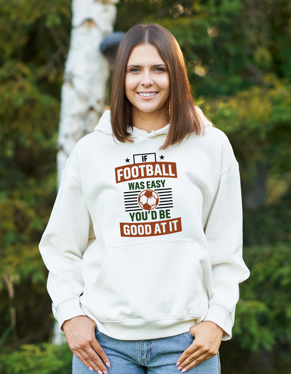 A lady wearing a white hoodie with the funny football slogan on the front that reads 'If Football Was Easy You’d Be Good at It'