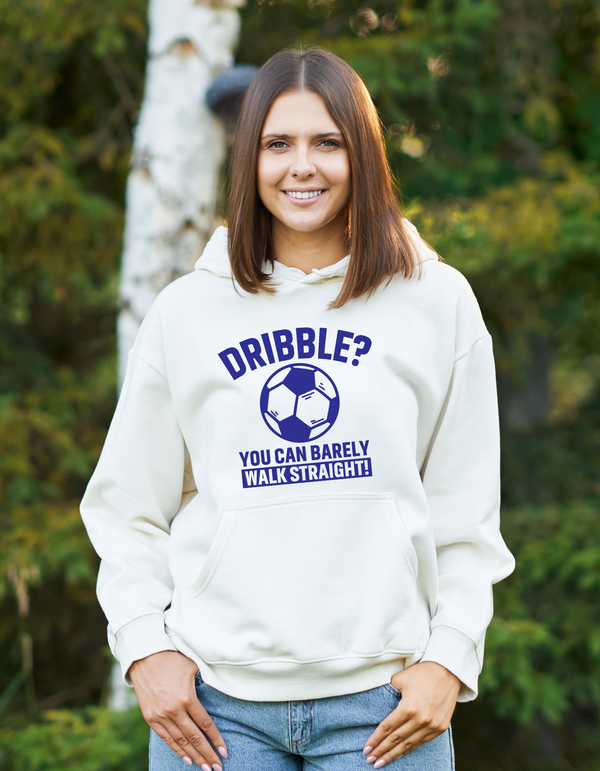A lady wearing a white hoodie with a funny football slogan on the front that reads 'Dribble You Can Barely Walk Straight!'
