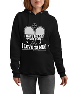 A lady wearing a black hoodie with 'I Hate To Lose More Than I Love To Win – Jimmy Connors' funny tennis slogan on the front