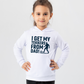 A young girl wearing a white hoodie with the funny football slogan on the front saying 'I Get My Tekkers From Dad'
