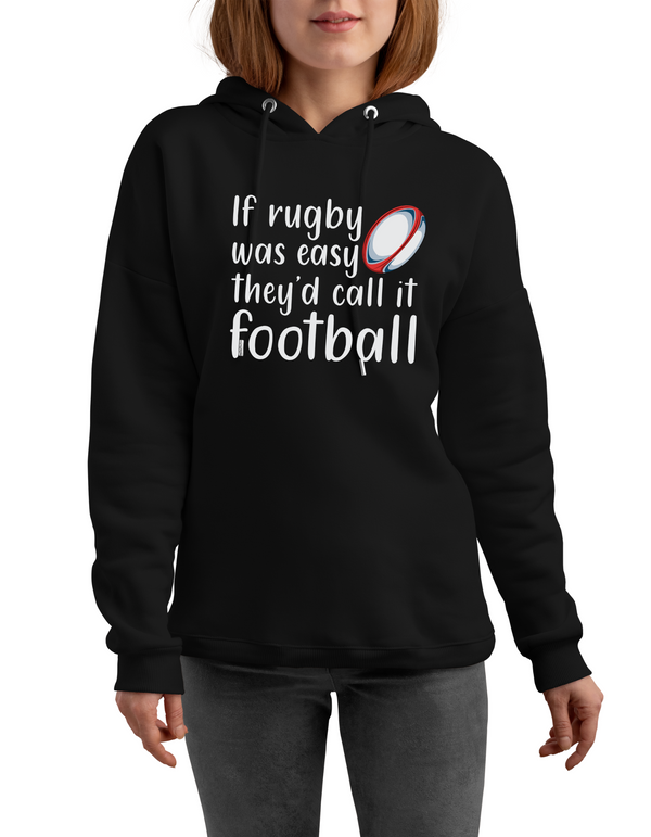 Person wearing a black hoodie with rugby-themed text and graphics with a Cows Corner slogan saying if rugby was easy they'd call if football