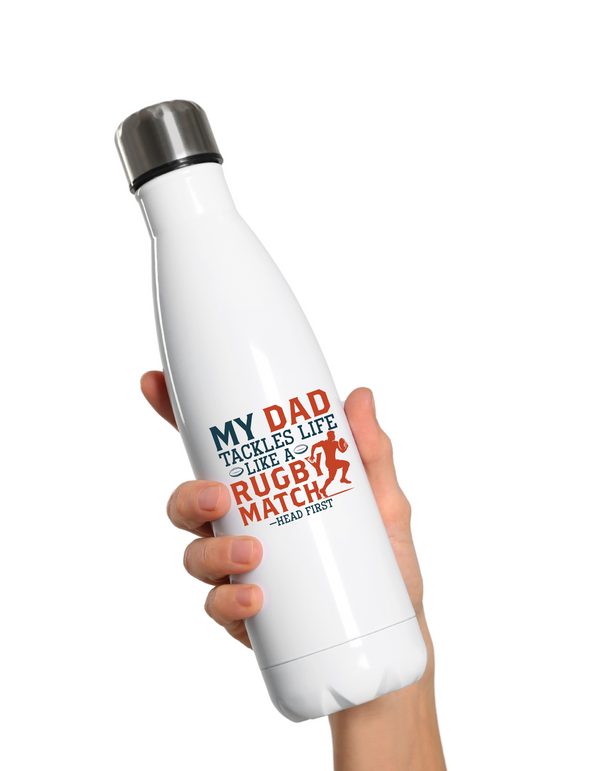 White water bottle with text held by a hand on a white background with the Cows Corner slogan saying My dad tackles life like a rugby match - head first.