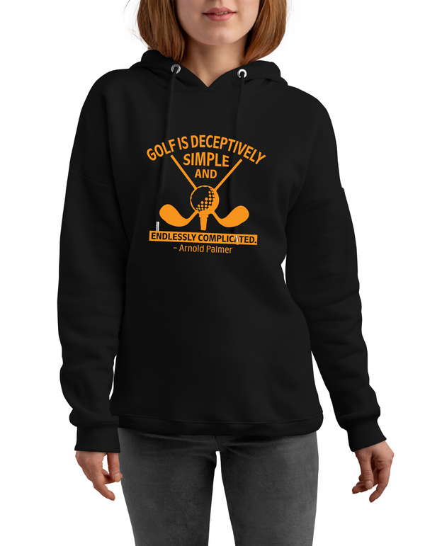 Black hoodie with yellow golf-themed design and text, worn by a person with a Cows Corner slogan saying Golf is deceptively simple and endlessley complicated - Arnold Palmer