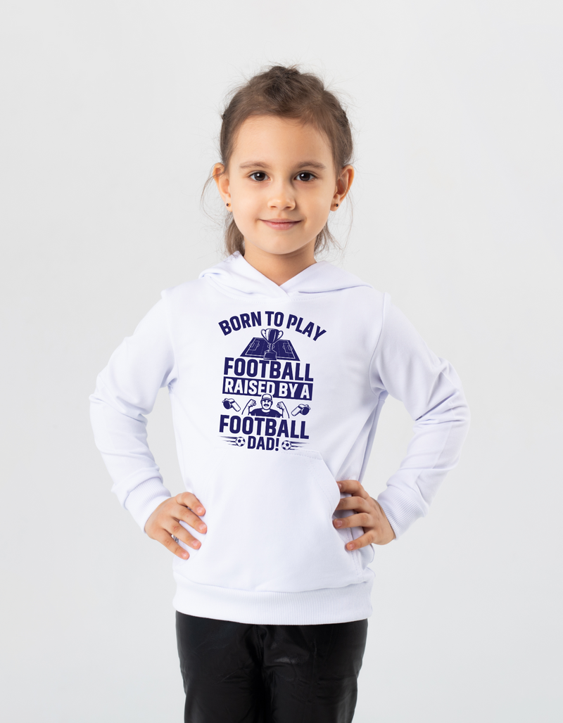 A little girl wearing a white hoodie with the funny football saying that says I love my dad 'Born To Play Football. Raised by a Football Dad!'