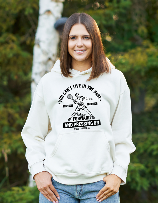 A lady wearing funny tennis white hoodie featuring the slogan on the front 'A white funny tennis t-shirt featuring the slogan on the front 'You Can’t Live in the Past, You’ve Got To Keep Looking Forward and Pressing On – Pete Sampras'