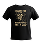 Black t-shirt with yellow text and graphic on a white background. This is a Cows Corner t-shirt with the funny darts slogan that reads 'Bullseyes And Bedtime Stories With Dad'. Cows Corner gifts are perfect for sport-mad fans, these gifts work brilliantly for birthdays, new baby celebrations, Father’s Day, Mother’s Day, Christmas, anniversaries, thank you gifts, end-of-season team awards, graduations, retirements, and just-because moments when you want to raise a smile. 
