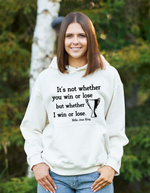 A lady wearing a white hoodie with the funny tennis slogan on the front reading 'It’s Not Whether You Win or Lose but Whether I Win or Lose – Billie Jean-King!