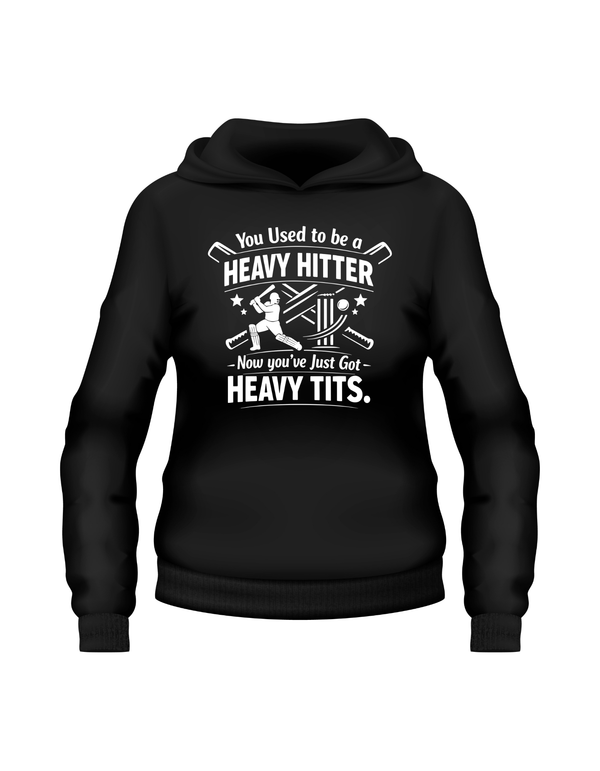 Black hoodie with white text and graphic on a white background. This is a Cows Corner hoodie with the funny cricket birthday slogan that reads 'You Used to be a Heavy Hitter. Now you’ve Just Got Heavy Tits.' Cows Corner gifts are perfect for sport-mad fans, these gifts work brilliantly for birthdays, new baby celebrations, Father’s Day, Mother’s Day, Christmas, anniversaries, thank you gifts, end-of-season team awards, graduations, retirements, and just-because moments when you want to raise a smile. 
