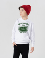 A little boy wearing a white hoodie with the funny football and dad loving slogan on the front which reads 'Messi, Ronaldo…Nah ’My Dads the Real Goat!'