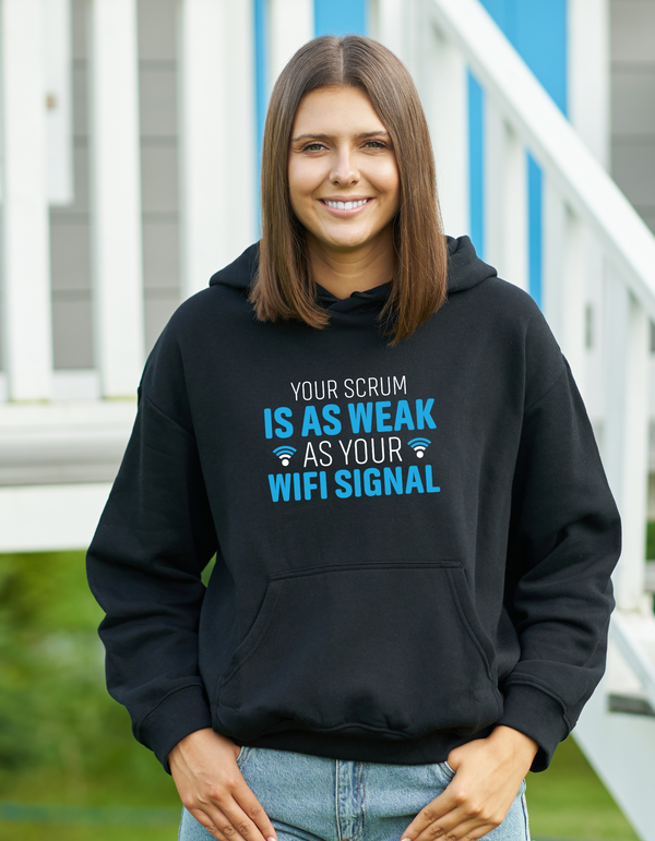 Person wearing a black hoodie with humorous text in an outdoor setting with a Cows Corner slogan saying Your scrum is as weak as your wifi signal.