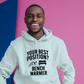A man wearing a white hoodie that has the funny football slogan on the front that reads 'Your Best Position? Bench Warmer'