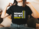 A lady wearing a black t-shirt with Wanna See My Googly? on the front. A Funny Cricket T-Shirt, Funny Cricket T-Shirt, Premium Fabric, Multiple Adult Sizes