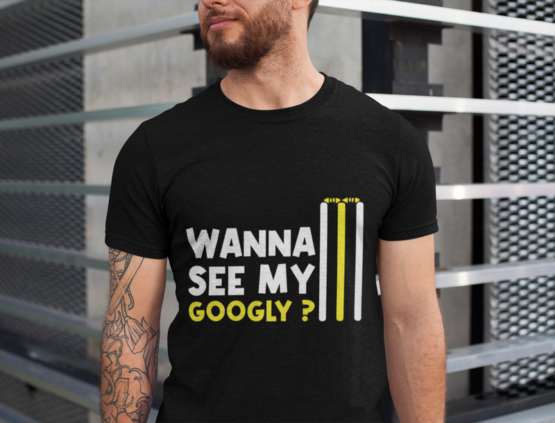 A man wearing a black t-shirt with Wanna See My Googly? on the front. A Funny Cricket T-Shirt, Funny Cricket T-Shirt, Premium Fabric, Multiple Adult Sizes