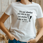 A lady wearing a white t-shirt with the funny tennis slogan on the front reading 'It’s Not Whether You Win or Lose but Whether I Win or Lose – Billie Jean-King!