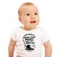 Baby wearing a white onesie with a humorous graphic and text.