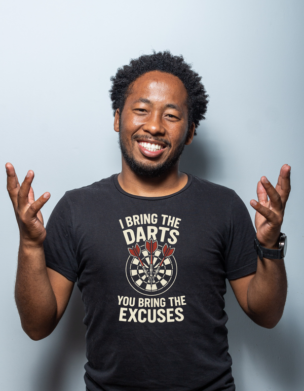 Man wearing a black t-shirt with a motivational message on a light gray background with the cows corner slogan saying I Bring the Darts You Bring the Excuses