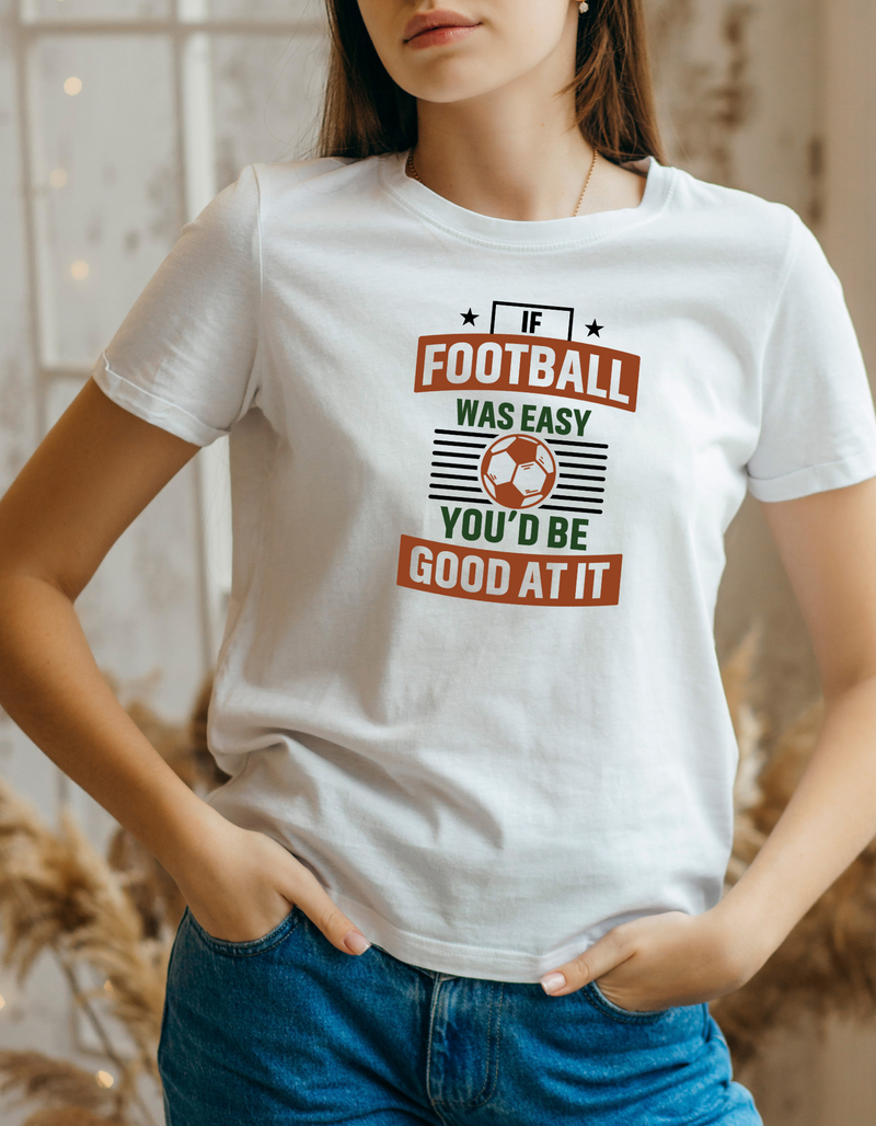 A lady wearing a white T-shirt with the funny football slogan on the front that reads 'If Football Was Easy You’d Be Good at It'