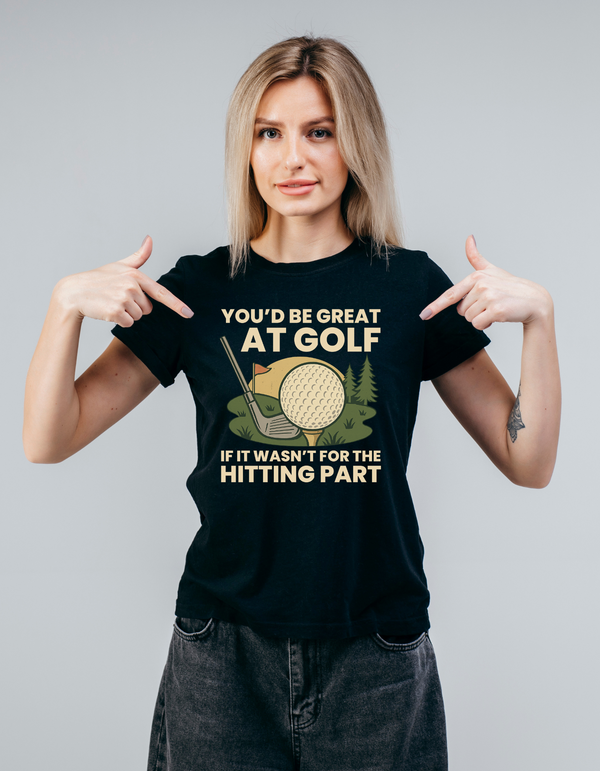 Woman wearing a black t-shirt with a humorous golf graphic and text with Cows Corner slogan, you'd be great at golf if it wasn't for the hitting part.