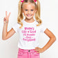 A little girl wearing a white t-shirt with Mums Like A Good All-rounder, Does Everything on the front. A T-Shirt. Premium Fabric, Multiple Junior Sizes, Perfect for Boys and Girls