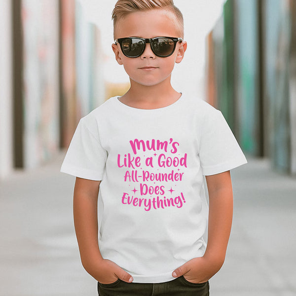 A little boy wearing a white t-shirt with Mums Like A Good All-rounder, Does Everything on the front. A T-Shirt. Premium Fabric, Multiple Junior Sizes, Perfect for Boys and Girls