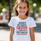 Young girl wearing a white t-shirt with a humorous message, standing outdoors, with a slogan on the front saying 'Dad’s My Coach My Biggest Fan and My Post-Match Snack Provider!