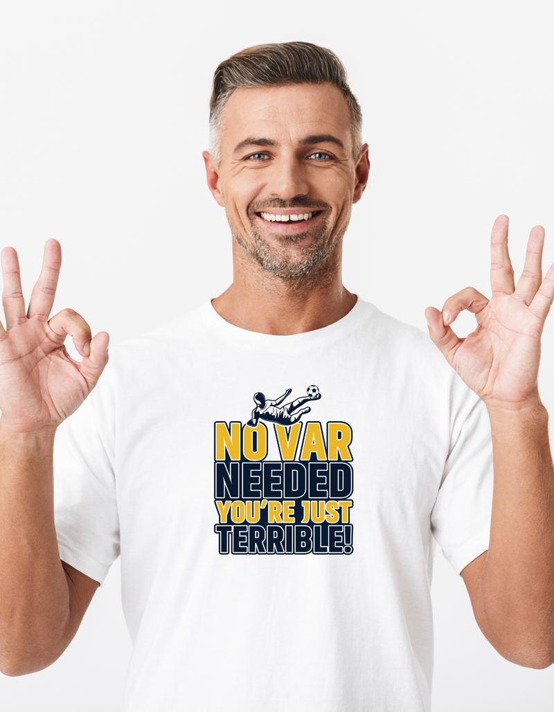 A man wearing a white t-shirt with the funny football slogan on the front that reads 'No VAR Needed You’re Just Terrible'