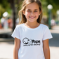 A little girl wearing a white t-shirt with tennis slogan on the front that reads 'Mum Serves Up Love and Aces'.