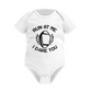 White baby onesie with black text and football graphic on a white background with a Cows Corner slogan saying run at me I dare you