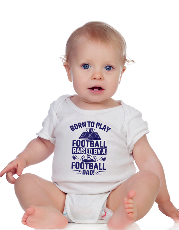 A little baby wearing a white baby grow with the funny football saying that says I love my dad 'Born To Play Football. Raised by a Football Dad!'