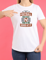 A lady wearing a white T-shirt with the funny football slogan on the front that reads 'If Football Was Easy You’d Be Good at It'