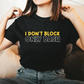 A lady wearing a black t-shirt with I Don't Block, Only Bash on the front. 
 A Funny Cricket Tee, Premium Fabric, Multiple Adult Sizes