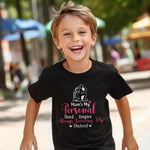 A little boy wearing a black t-shirt with Mum's My Personal Third Umpire, Always Reviewing My Choices on the front of the T-Shirt. Funny Cricket T-Shirt, Premium Fabric, Multiple Adult Sizes