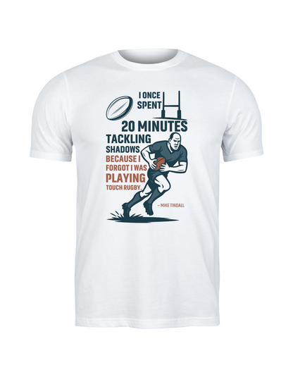 White t-shirt with graphic design and text on a white background - I Once Spent 20 Minutes Tackling Shadows Because I Forgot I Was Playing Touch Rugby – Mike Tindall
