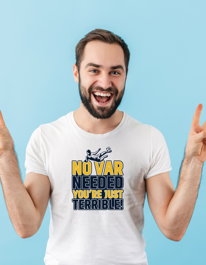 A a man wearing a white t-shirt with the funny football slogan on the front that reads 'No VAR Needed You’re Just Terrible'
