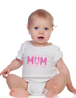 A a baby wearing white baby grow with a lovely tennis saying on the front that reads 'Tennis with Mums. Best. Day. Ever!'