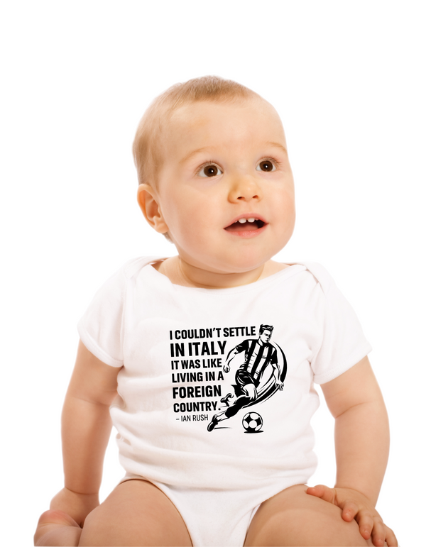 Baby wearing a white onesie with text and graphic design on a white background with the Cows Corner slogan, I couldn't settle in Italy, it was like living in a foreign country - Ian Rush