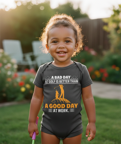 Child wearing a onesie with a humorous golf quote outdoors.  The baby is wearing a Cows Corner baby grow with a funny golf slogan 'A Bad Day at Golf Is Better Than a Good Day at Work'. Cows Corner gifts are perfect for sport-mad fans, these gifts work brilliantly for birthdays, new baby celebrations, Father’s Day, Mother’s Day, Christmas, anniversaries, thank you gifts, end-of-season team awards, graduations, retirements, and just-because moments when you want to raise a smile. 
