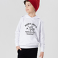 A little boy wearing a white hoodie with Mums Like A Good Bat Grip, Always Holding Things Together on the front. A Funny Cricket T-Shirt, Premium Fabric, Multiple Junior Sizes, Perfect for Boys and Girls