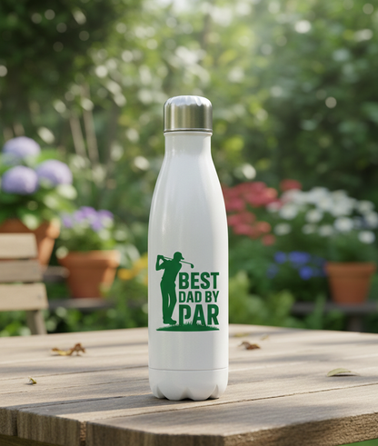 White water bottle with green text and graphic on a wooden table with a garden background. This is a Cows Corner water bottle with a funny golf slogan 'Best Dad by Par'. Cows Corner gifts are perfect for sport-mad fans, these gifts work brilliantly for birthdays, new baby celebrations, Father’s Day, Mother’s Day, Christmas, anniversaries, thank you gifts, end-of-season team awards, graduations, retirements, and just-because moments when you want to raise a smile. 
