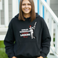A lady wearing a black hoodie with Bowled & Bamboozled And Still Looking Better Than You on the front, A Funny Hoodie.  Funny Cricket Hoodie, Premium Fabric, Multiple Adult Sizes