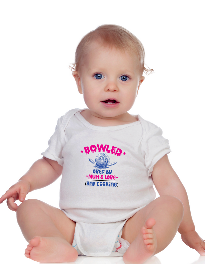 A baby wearing a baby grow with Bowled Over by Mums Love and Cooking, on the front – Funny Cricket Baby Bodysuit, Organic or In-Conversion to Organic Cotton, Self Fabric Bound Neckline, Cuffs and Leg Openings.